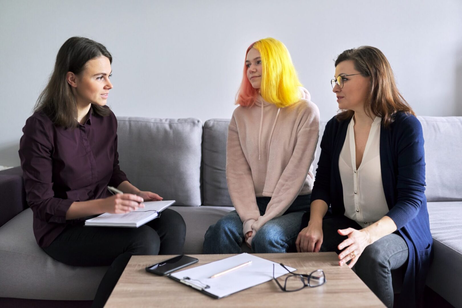 Social worker, psychologist, counselor at meeting with mature woman and her teenage daughter. Psychology, family mental health, adolescence problems, mother daughter child parent relationships